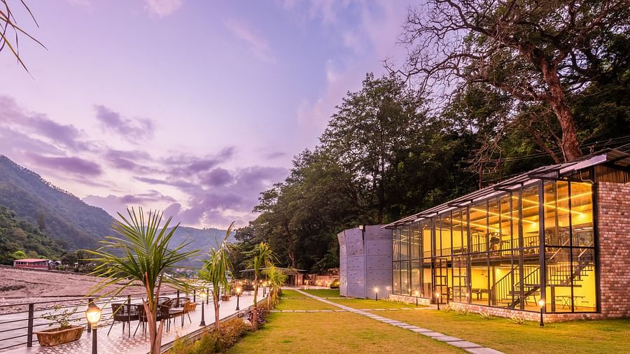 Exterior facade view of DLS Divine River Resort and Spa with stunning lighting and garden area taken in the evening 